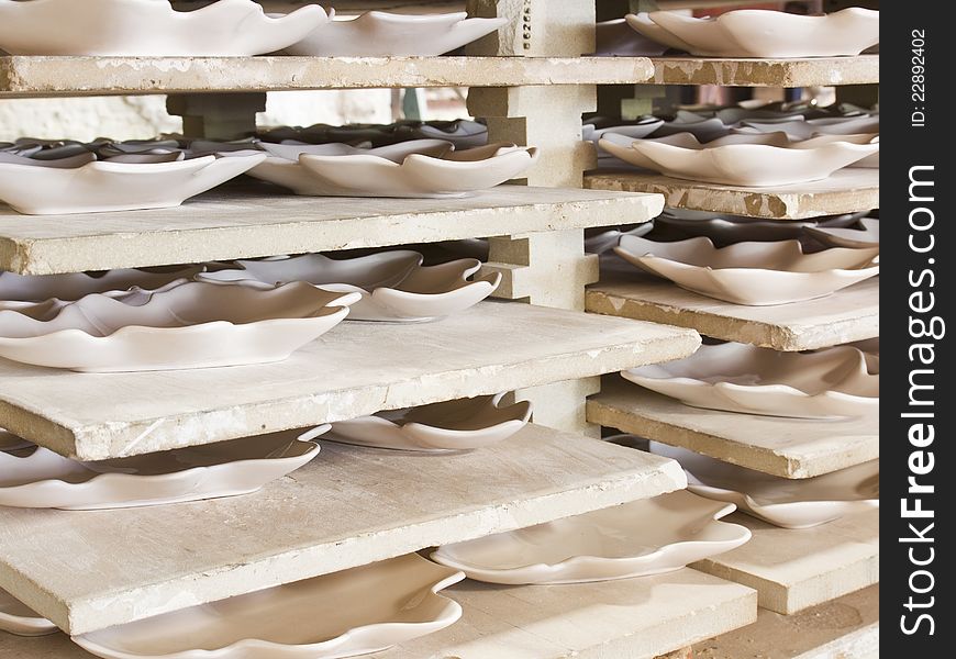 Ceramic plates in racks in ceramic work shop
