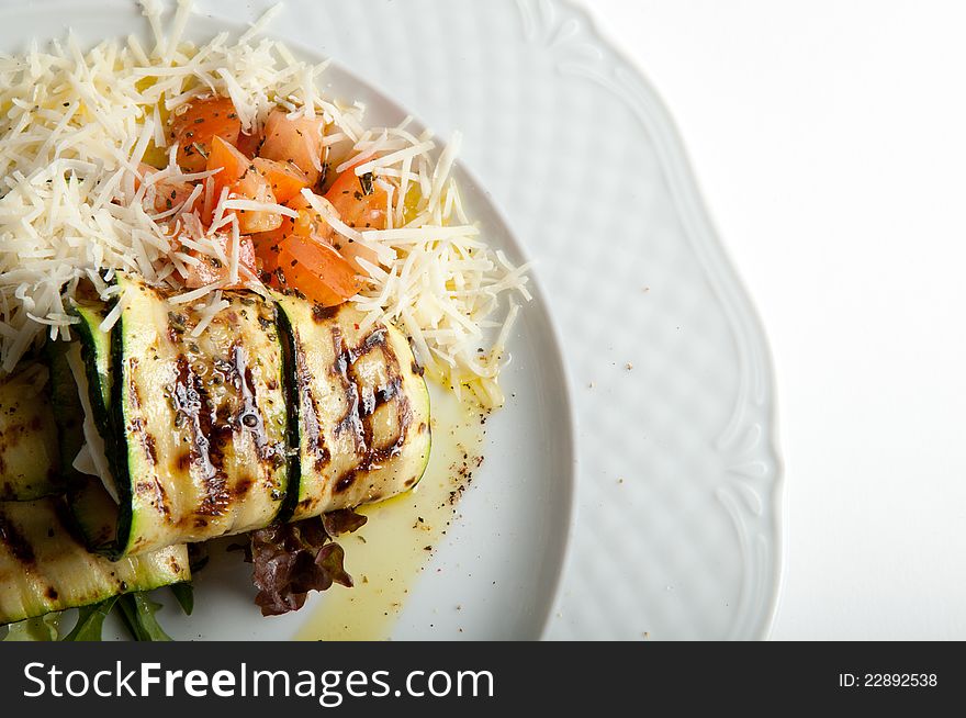 Grilled sqaush with tomatoes and cheese. Grilled sqaush with tomatoes and cheese