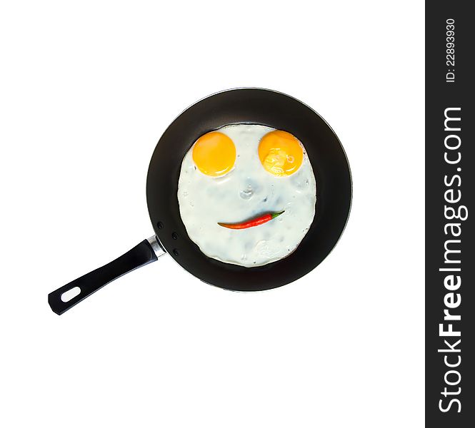 Smiley egg with red chilli on a pan. Smiley egg with red chilli on a pan