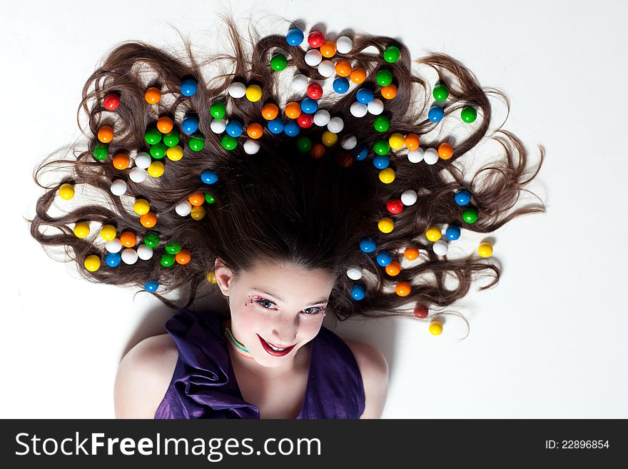 Pretty Girl with Candy Makeup and colorful Gumballs in her hair for Artistic Fun