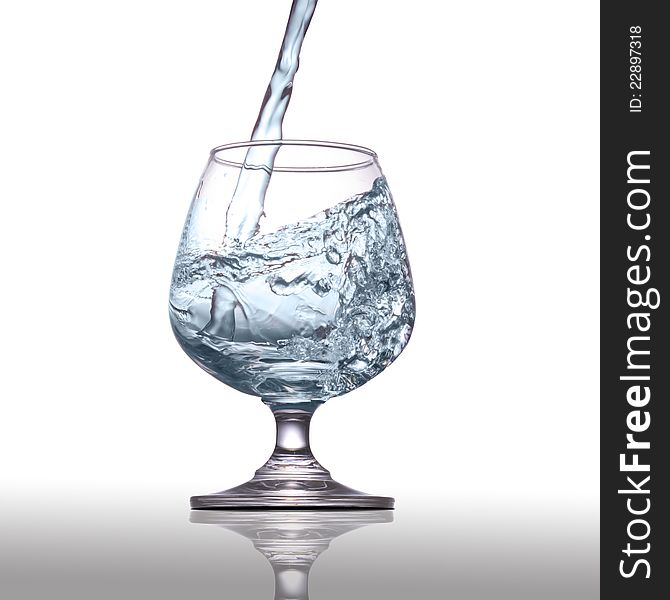 Water pouring into glass  on white background