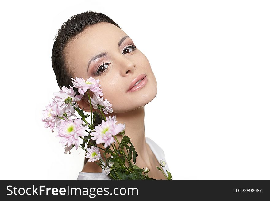 Beauty face of the young beautiful woman with colorful flowers isolated on white