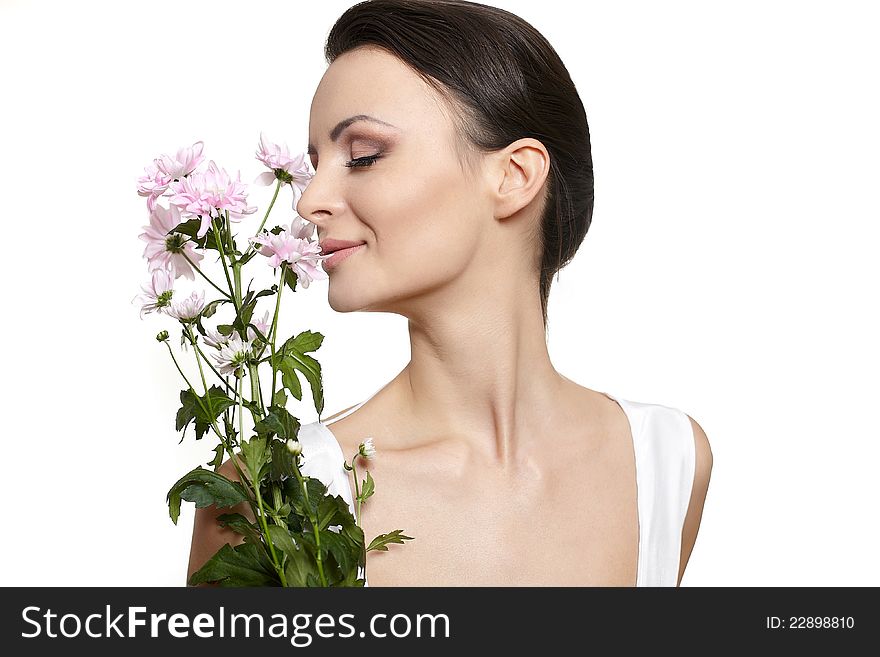 Beauty face of the young beautiful woman with colorful flowers isolated on white