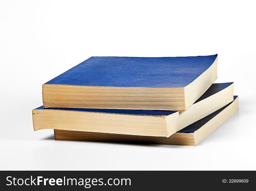 Three blank blue books on white