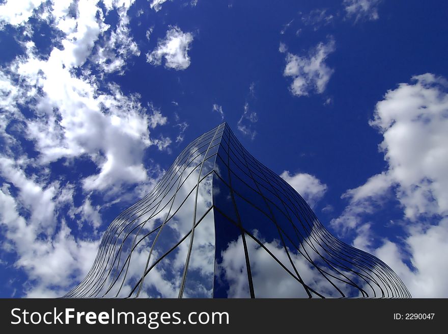 Office building details reflecting, blue sky and clouds in windows. Office building details reflecting, blue sky and clouds in windows