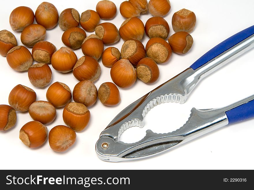 Nutcracker and nuts, on white