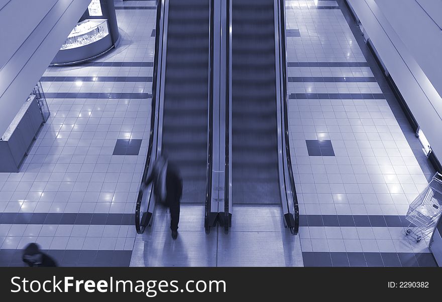 People on escalator in shopping center