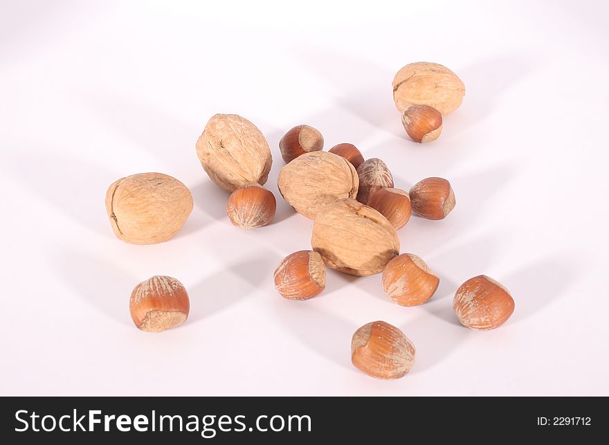 Wallnuts and chestnuts on a white background.