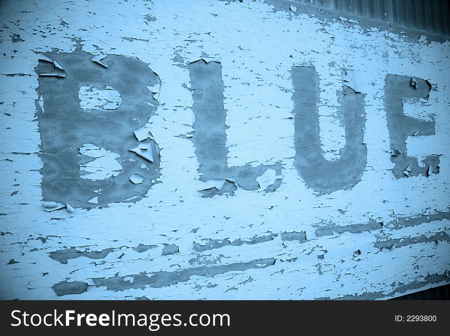 Old sign with peeling paint that says Blue. Old sign with peeling paint that says Blue