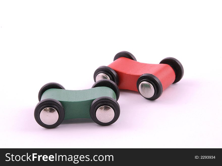 Colourfull toy wooden cars on a white background