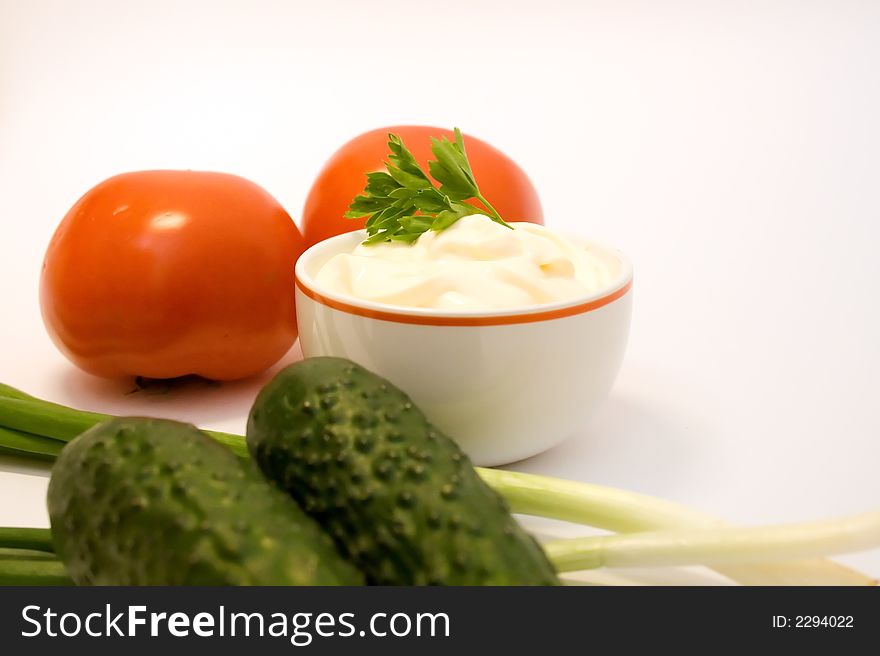 Mayonnaise with tomatos, leeks and cucumbers over white background. Mayonnaise with tomatos, leeks and cucumbers over white background