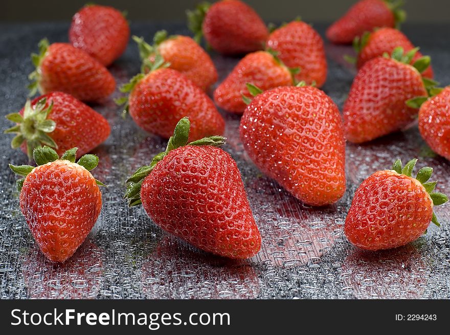 Fresh strawberryes close up shoot on metallic surface