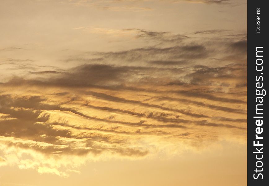 Streaky, golden, heavenly looking clouds at dawn. Streaky, golden, heavenly looking clouds at dawn.