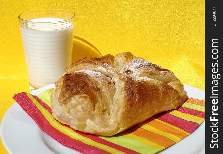 Sweet pastry and a glass of milk. Sweet pastry and a glass of milk