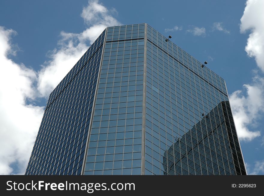 A corporate skyscraper against the blue sky