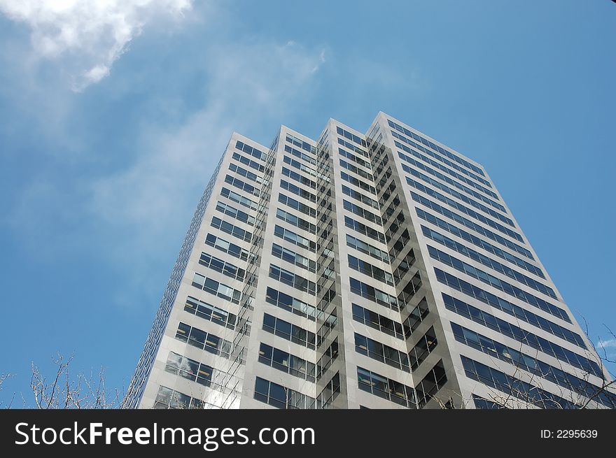 A corporate skyscraper against the blue sky