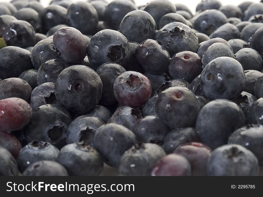 A pile of blueberries on white