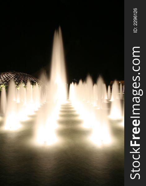 Night capture of a dancing lighted fountain. Night capture of a dancing lighted fountain.