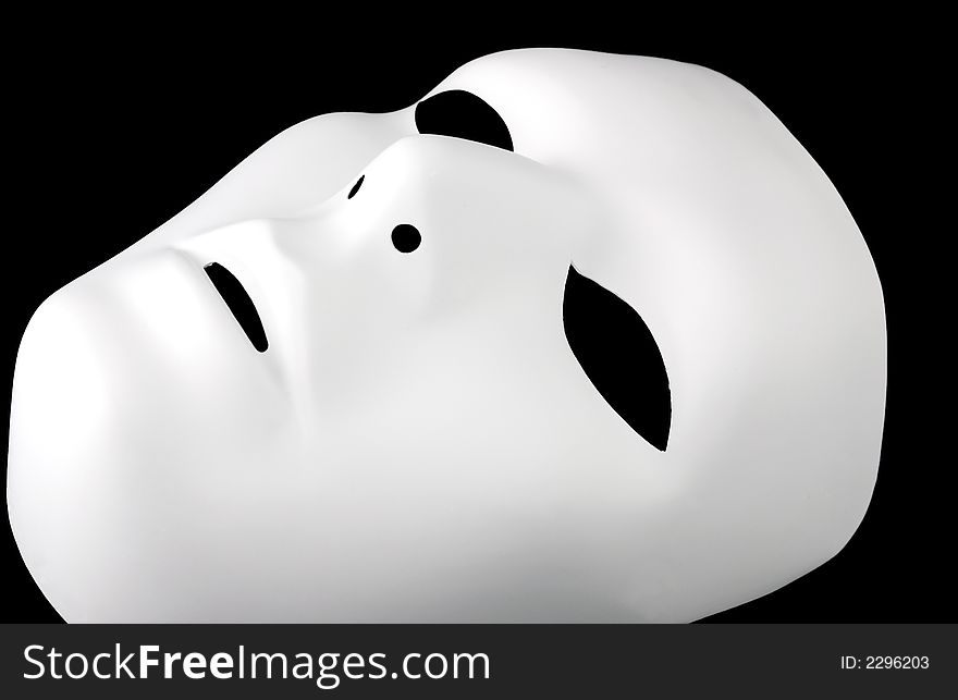 A different view of a solid, flat white, full face, expressionless mask that has been isolated on a black background. A different view of a solid, flat white, full face, expressionless mask that has been isolated on a black background.