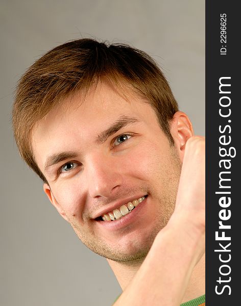 Portrait of young smiling guy emotionally gesticulating hands, close up, vertical. Portrait of young smiling guy emotionally gesticulating hands, close up, vertical