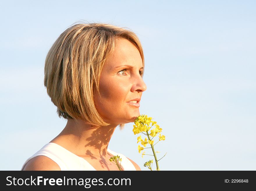 A beautiful young woman and yellow flowers. A beautiful young woman and yellow flowers