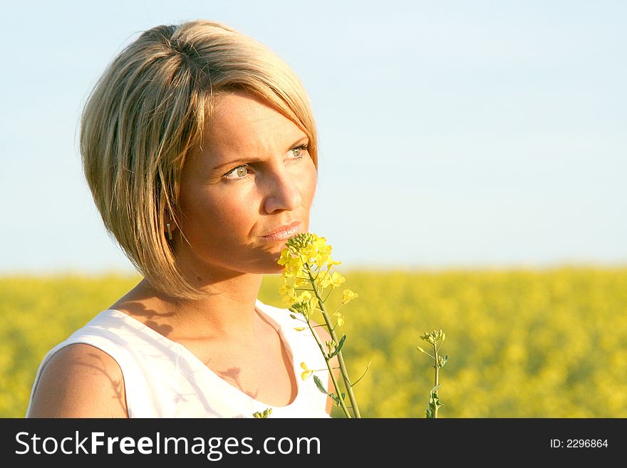 A beautiful young woman and yellow flowers. A beautiful young woman and yellow flowers