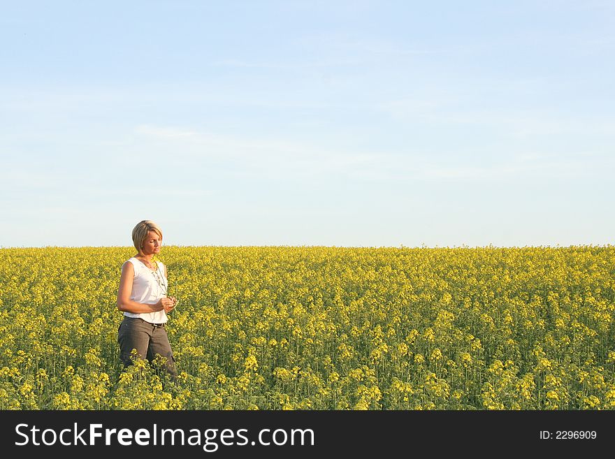 A beautiful young woman and yellow flowers. A beautiful young woman and yellow flowers