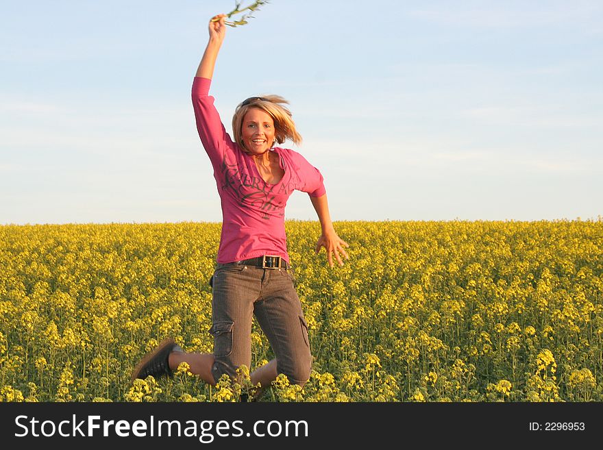 A beautiful young jumping woman and yellow flowers. A beautiful young jumping woman and yellow flowers