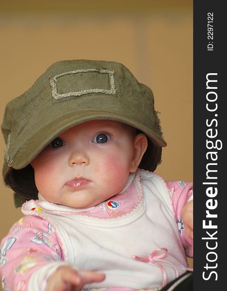 A litle baby in a big cap. A litle baby in a big cap