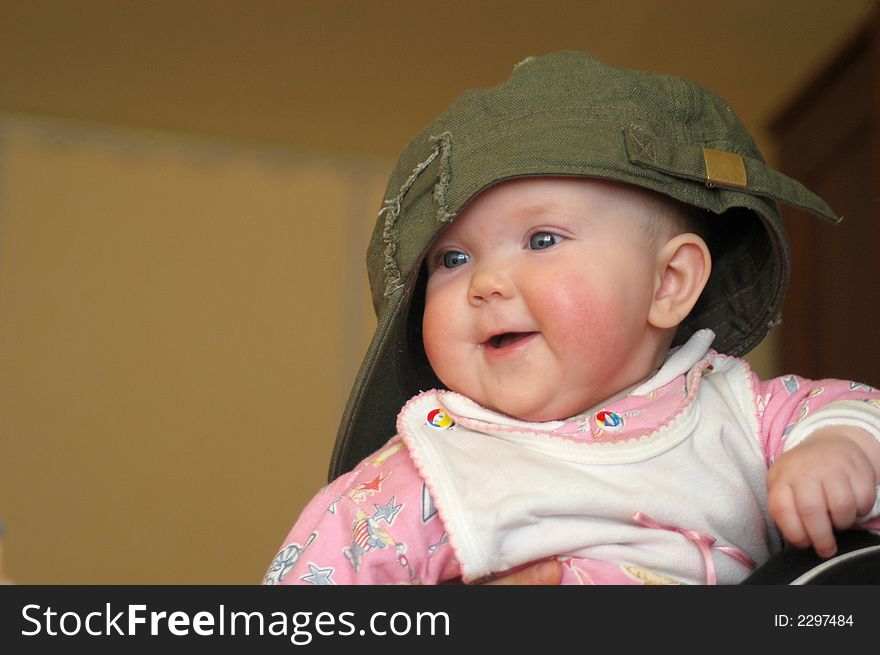 A litle baby in a big cap. A litle baby in a big cap