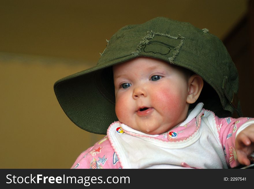 A litle baby in a big cap. A litle baby in a big cap