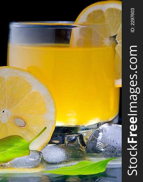 Cold cocktail with lemon on black background