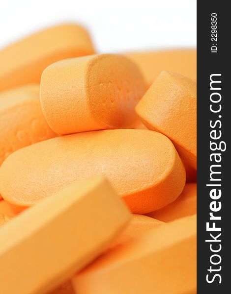 Pills over white background. Soft focus. Orange Color.