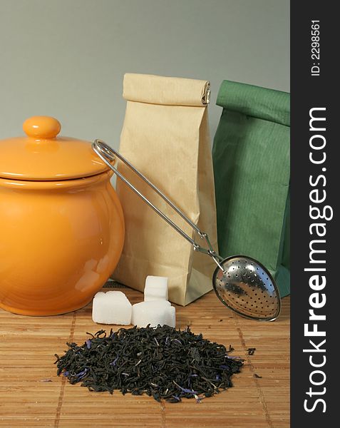 Aromatic flower tea leaves, sugar and strainer