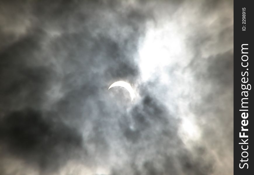 Partial solar eclipse in the clouds. Ukraine. March 29, 2006.