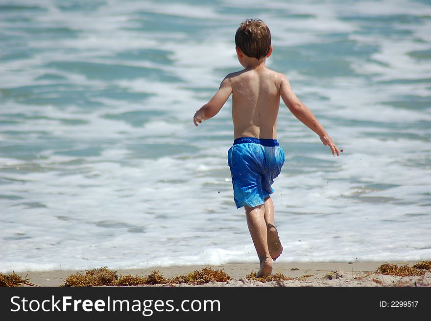 Little boy playing at the beach. Little boy playing at the beach.