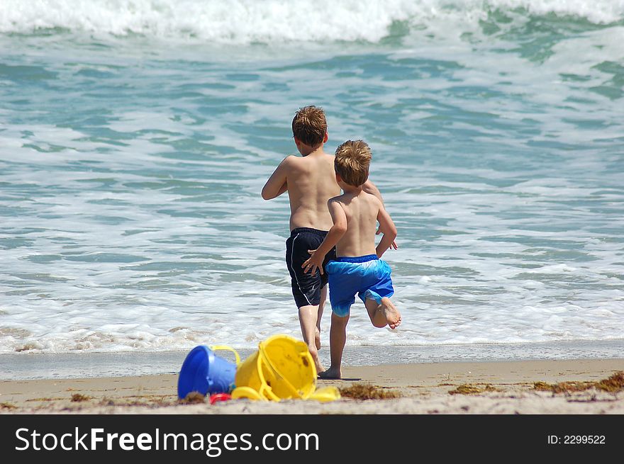 Two brothers playing at the beach. Two brothers playing at the beach.