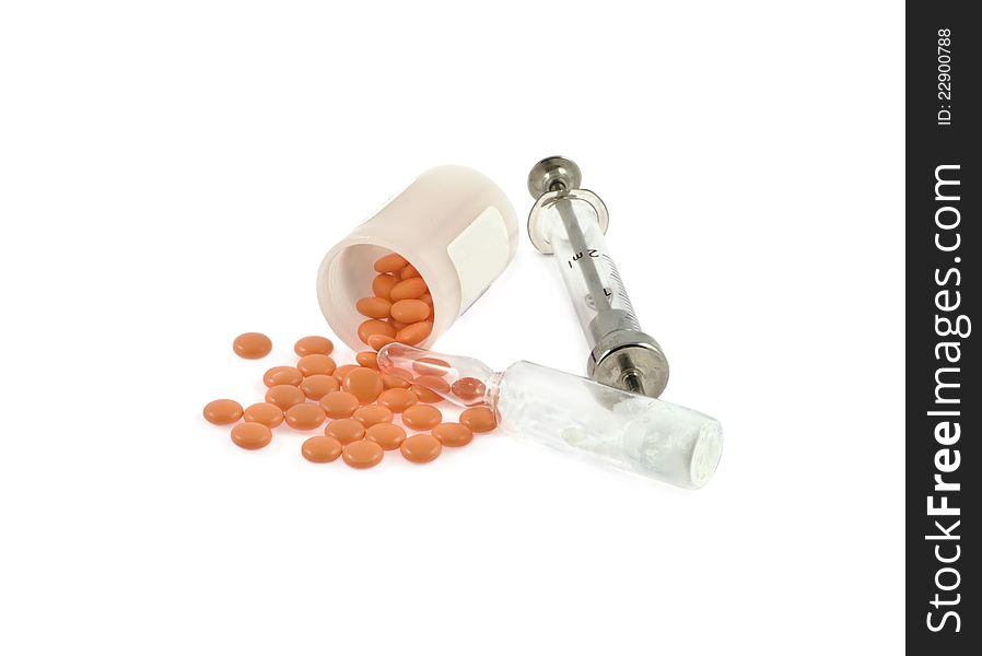 Syringe, ampoule and pills on a white background
