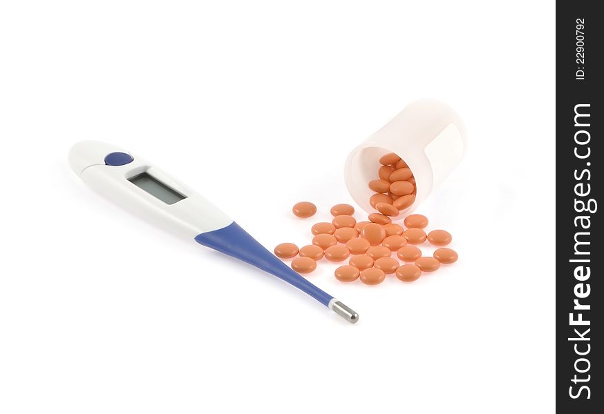 Electronic thermometer and orange pills poured out from a jar. Electronic thermometer and orange pills poured out from a jar