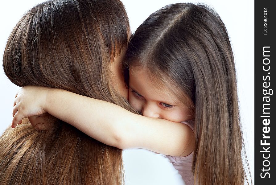 Little cute girl hugging her mother's neck.isolated. Little cute girl hugging her mother's neck.isolated