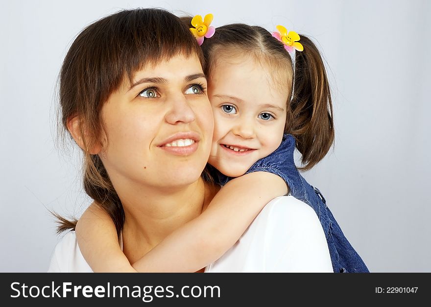 Little cute girl hugging her mother.Isolated