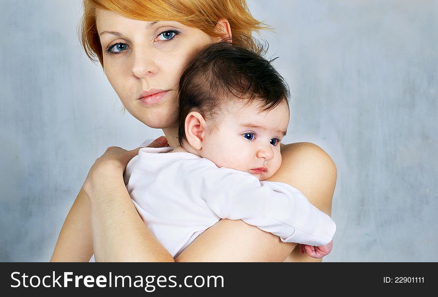 Portrait of a beautiful happy mother and the little cute baby. Portrait of a beautiful happy mother and the little cute baby