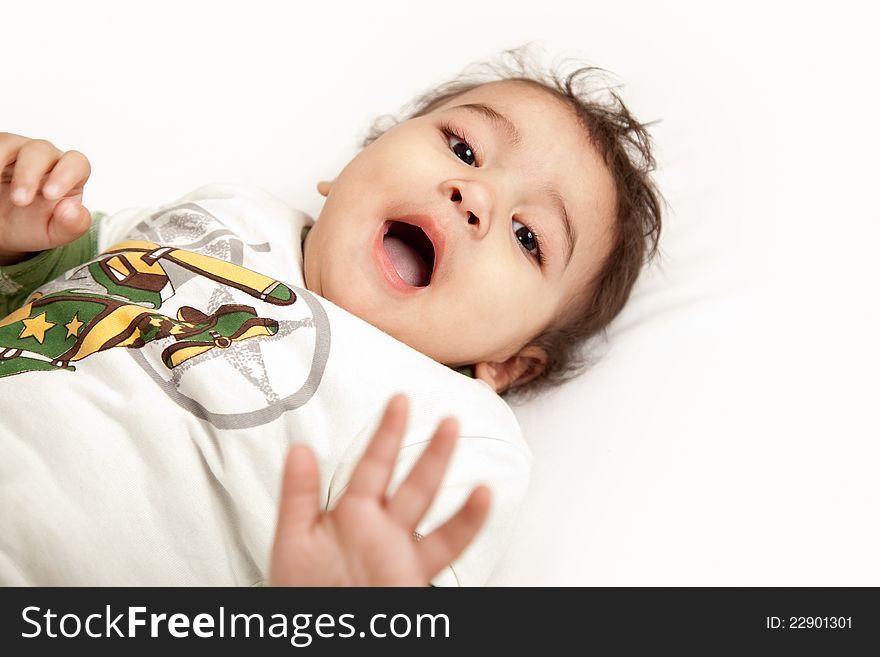 Adorable Indian baby laughing a over white background