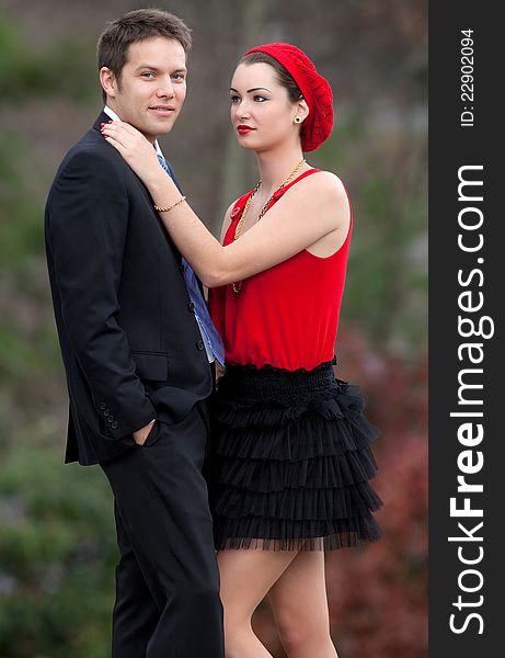 A portrait of a happy, attractive young couple in a lovely wooded area. A portrait of a happy, attractive young couple in a lovely wooded area