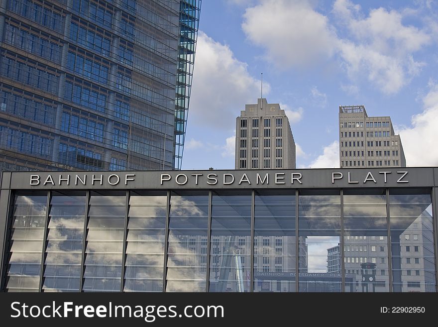 Enterance to Potsdamer Platz U-Bahn station in Berlin with skyscrapers in background