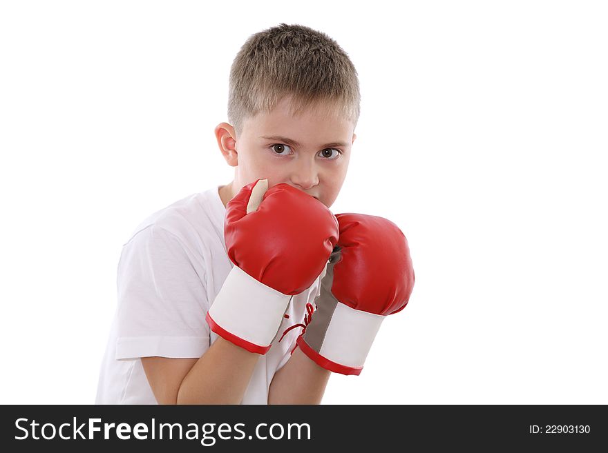 A boy in red boxing gloves in defence position. A boy in red boxing gloves in defence position