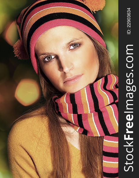 Beautiful young woman wearing worm colored hat and scarf. Beautiful young woman wearing worm colored hat and scarf
