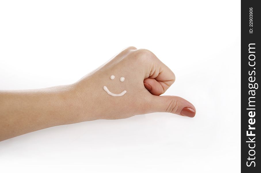 Hand with cream smiley on a white background