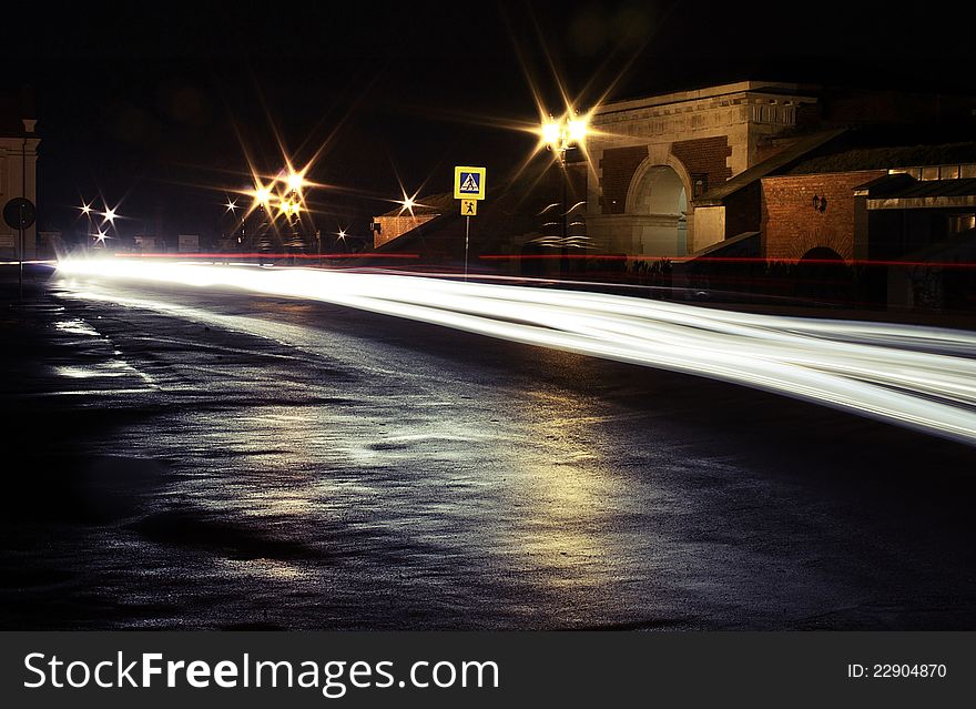 Car trailing white lights at night on the street. Car trailing white lights at night on the street