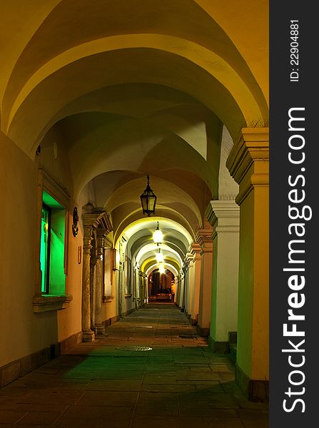 Narrow passageway with arches at night with lights in Zamosc. Narrow passageway with arches at night with lights in Zamosc